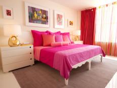 White Bedroom With Hot-Pink Bedding, Multicolor Artwork and Gold Lamps