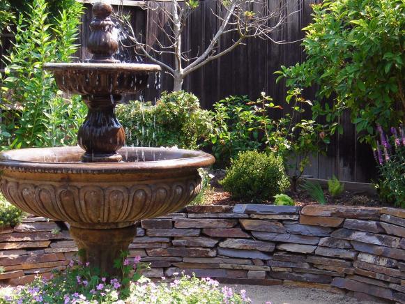 Traditional Fountain and Stone-Lined Landscaping Beds