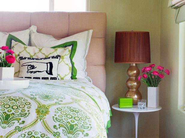 Green Bedroom With Pink Headboard, White Table and White Bedding