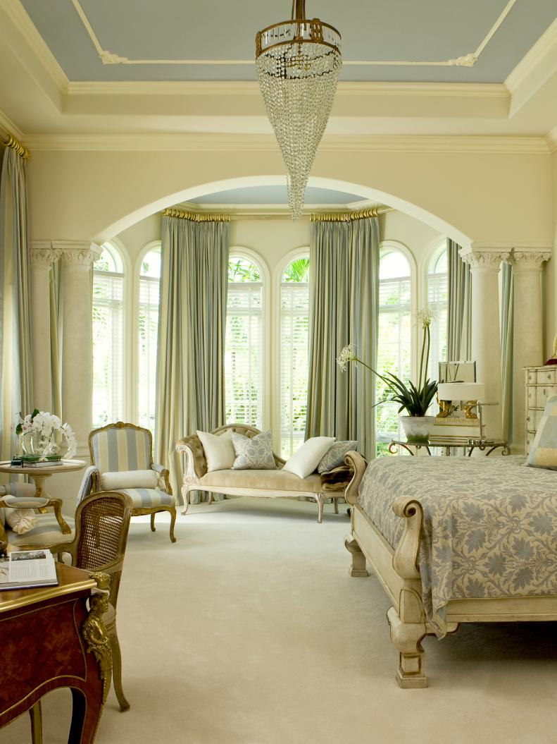 Neutral Bedroom with Teardrop Chandelier and Blue Ceiling