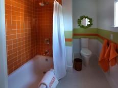 Whimsical Bathroom With Orange Shower Tiles and Green Accents