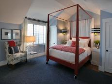 Bedroom With Red Canopy Bed on Wheels, Striped Lights and Sitting Area