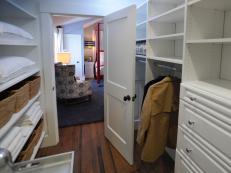 Walk-In Closet With White Open Shelves, Drawers and Hardwood Floor