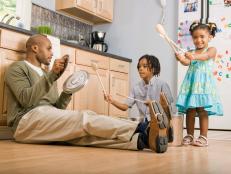 Dad and Two Kids Playing on Kitchen Floor