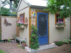 White Garden Shed with a Blue Door