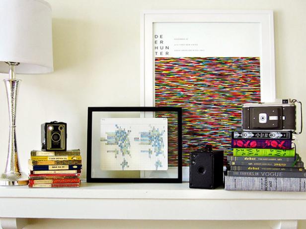 Mantel With Multicolor Books, Art and Old-Fashioned Camera Collection