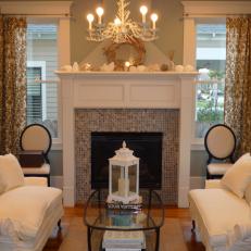Cottage Living Room With White Sofas and Large Mantel