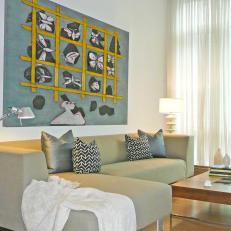 Bright Living Room With Gray Sofa and Colorful Artwork
