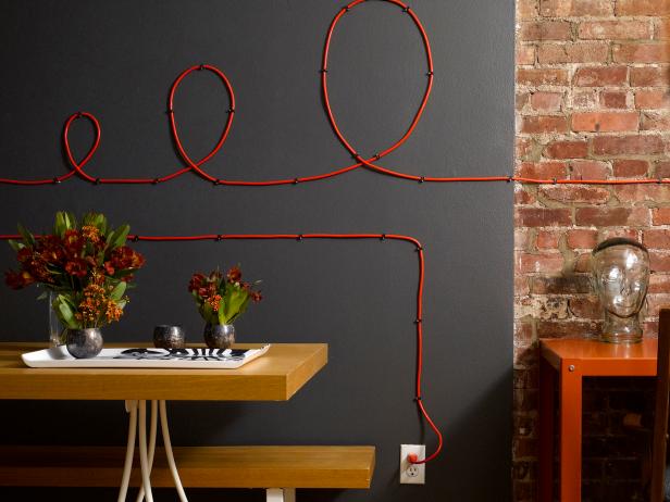 Office With Red Cable Cord Art on Black and Exposed Brick Wall