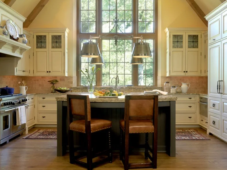 English Manor Styled Kitchen With High Ceilings Country Kitchen With Hardwood Floors, Island and White Cabinets