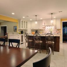 Yellow Transitional Kitchen With Wood Island and White Cabinets