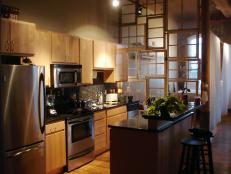 small kitchen with interior accent wall of windows