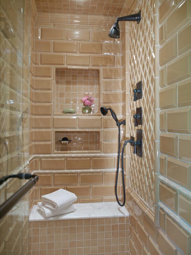 Beige Tile Shower With Built-in White Bench and Black Fixtures