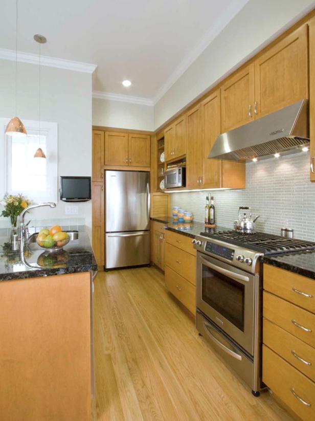 Galley Kitchen With Stainless Steel Appliances and Light Wood Cabinets 