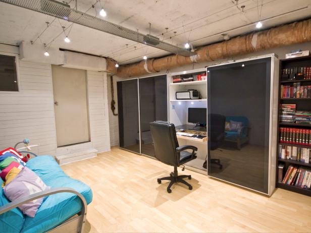 Basement Home Office With Built-In Desk and Teal Futon