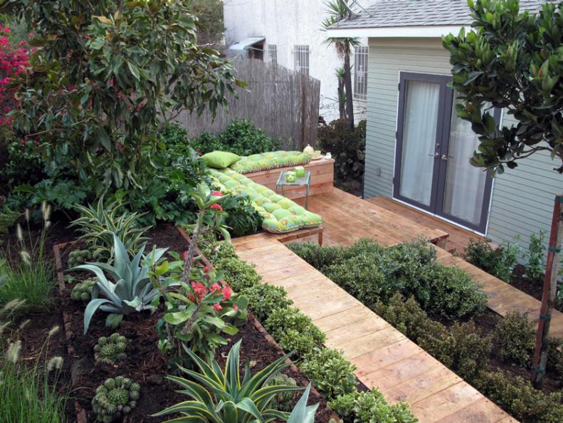 Lush Backyard with Green Cushioned Seating Area 