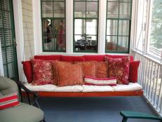 Porch Swing Full of Red Throw Pillows