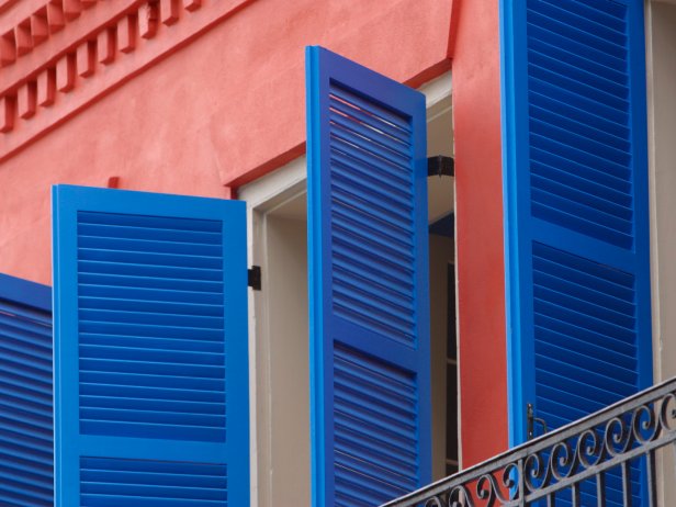 Striking Blue Shutters and Red Wall