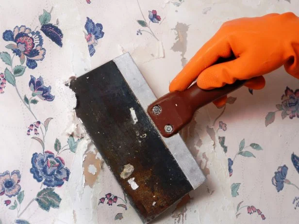 Wallpaper Being Removed With a Scraper
