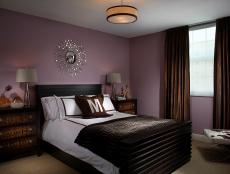 Purple and Brown Bedroom With Sunburst Mirror