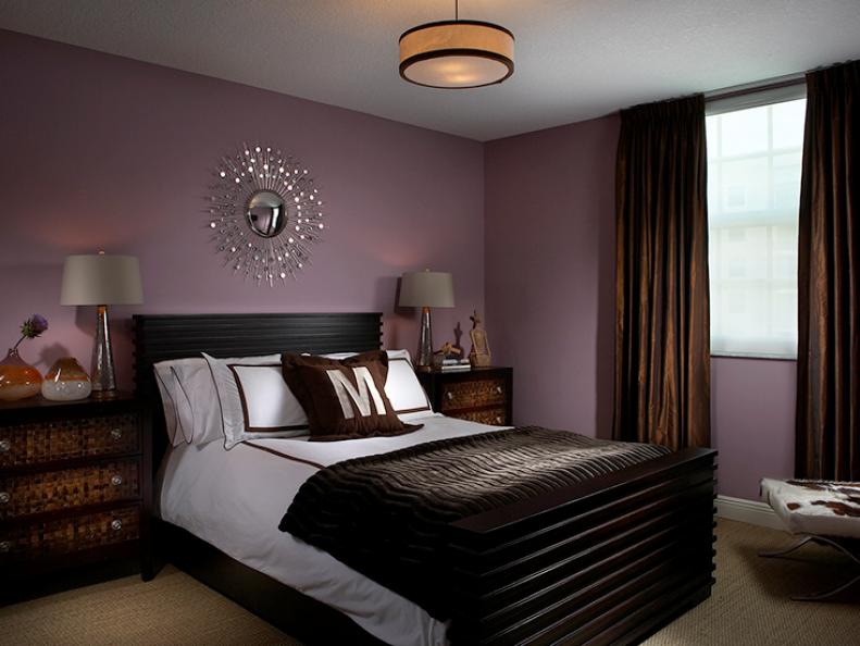 Purple and Brown Bedroom With Sunburst Mirror