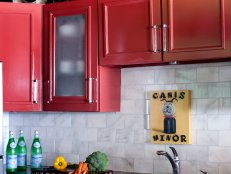 Kitchen With Blue Counters, White Tile Backsplash and Red Cabinets