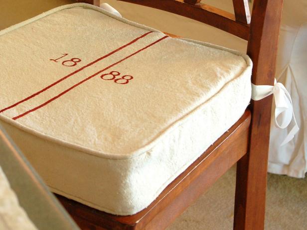 DIY grain sack barstool cushion with red numbering.