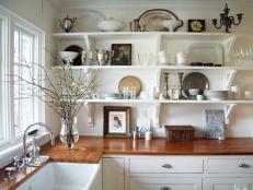 If your kitchen is short on cupboards or if you just want to make it seem more spacious, opt for open shelving. You can show off your favorite dishes while keeping your kitchen feeling open, airy and a little less small. Image courtesy of A Country Farmhouse.