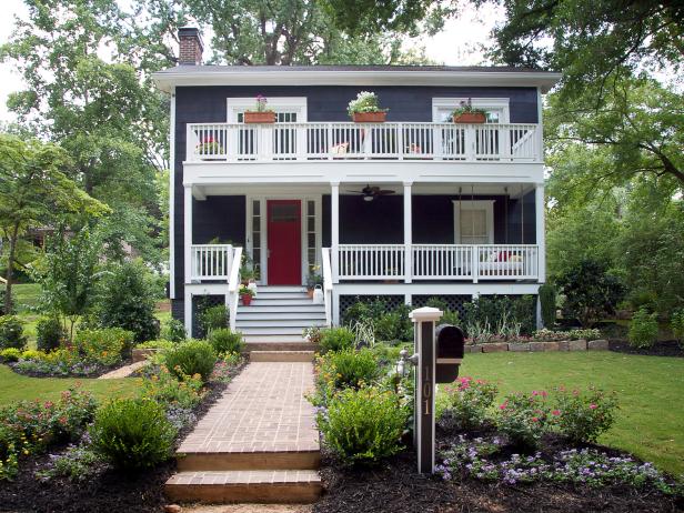 Blue Cape Cod With Red Door, White Porch Railing & Brick Walkway