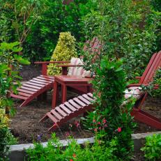 Red Adirondack Chairs in Garden 