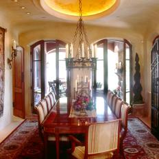Neutral Mediterranean Style Dining Room With Wrought Iron Chandelier