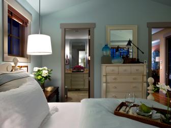Blue Guest Bedroom With Pendant Light and  Private Bathroom Entrance