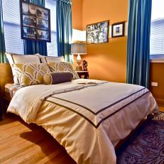 Eclectic Orange Bedroom With Bold Blue Curtains