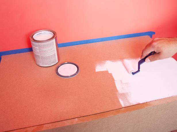 After the shelf has been securely fastened to the cleat, place a drop cloth to protect the surrounding area from paint splatter. Use paintbrush and roller to thoroughly coat interior and exterior surfaces. TIP: For a two-tone look, consider painting the exterior, but leaving the interior the natural tone of the MDF. This creates a nice contrast when the door is open.