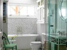 White Bathroom with Wood Paneled Walls and Slipper Tub