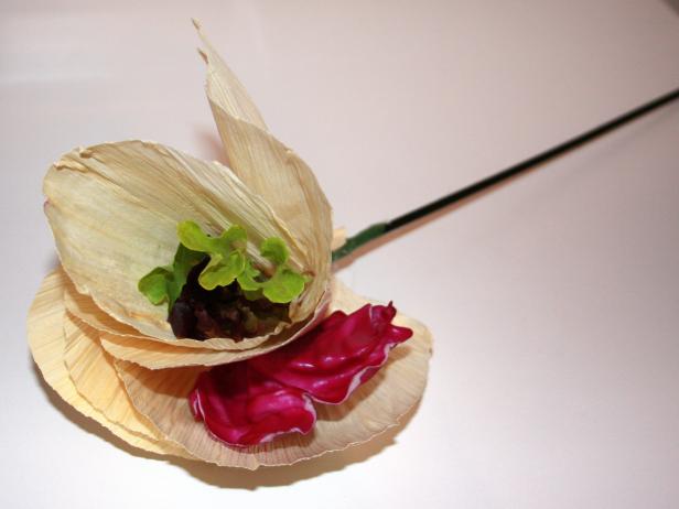 For a splash of color, secure baby greens between each petal with hot glue. Assemble 15 corn husk flowers.
