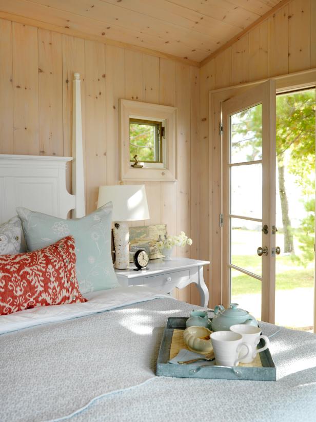 Light Wood Bedroom With White Poster Bed and Colorful Bedding