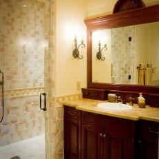 Wood Bathroom Vanity With Neutral Countertop and Large Mirror in Neutral Tile Traditional Bathroom 