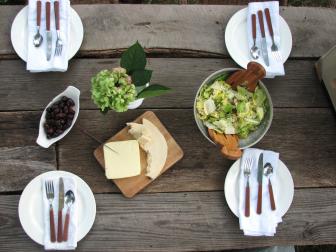 Garden Party Table Setting With White Plates and Rustic Tabletop