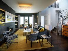 Family Room With Gray Focal Wall, Mustard-Colored Rug and Metal Chair