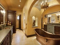 En Suite Bathroom With Two Wood Vanities and Freestanding Copper Tub