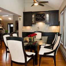 Traditional Black and White Dining Room With Glass Table and Custom Wet Bar