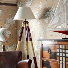 Sitting Area with Map Themed Wallpaper and Tripod Lamp