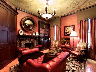 Traditional Library With Red Leather Chair and Marble Fireplace