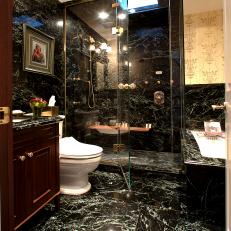 Elegant Marble Bathroom With Glass Enclosed Shower and Gold Fixtures