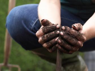 Woman With Hands in Soil