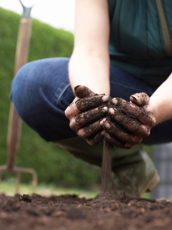 Woman With Hands in Soil