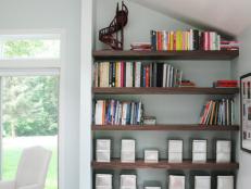 Brown Wood Shelves in Living Room Nook, with Sloped Ceiling.