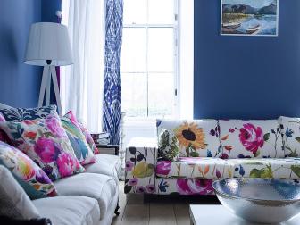 Blue Living Space With Floral Sofa and Pillows