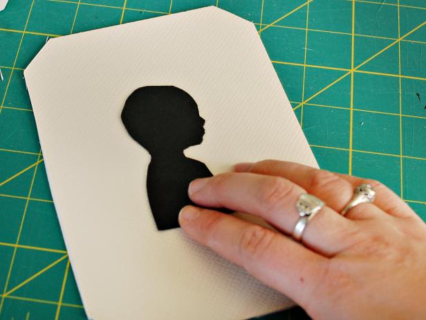 Center silhouette, then gently press down and hold in place while glue adheres.
